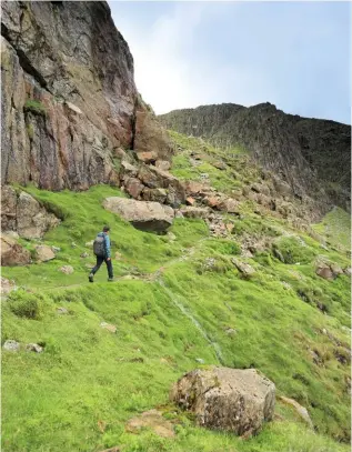  ??  ?? ▲ HIGH TIME The climbers’ traverse on Bow Fell treads a narrow ledge with crags stacked to one side and a good bit of air to the other.