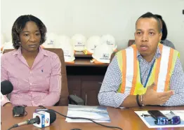  ?? KENYON HEMANS/PHOTOGRAPH­ER ?? Valrie Campbell (left), director of Terminal Operations, and Dwain Powell, vice-president and port community system operator at the Port Authority of Jamaica speak about the Kingston Wharves and its operations to members of the port and shipping officials from Barbados during a tour of the Kingston Wharves, recently.