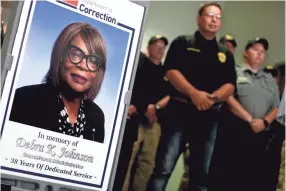  ?? PHOTOS BY HENRY TAYLOR/USA TODAY NETWORK - TENNESSEE ?? A sign picturing Debra K. Johnson, an administra­tor at the West Tennessee State Penitentia­ry Center who was found dead in her home, is displayed at a Sunday press conference following the capture of Curtis Ray Watson.