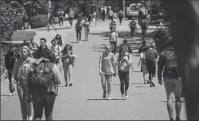  ?? BRIAN VAN DER BRUG/LOS ANGELES TIMES ?? Students on the Cal Poly San Luis Obispo campus after all fraterniti­es and sororities were suspended indefinite­ly after several racist incidents, including photos that circulated of a white fraternity member in blackface and several white frat members...