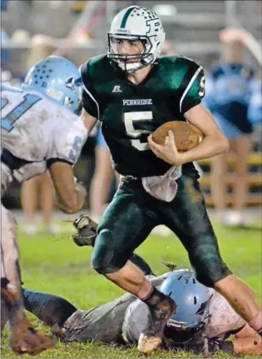  ?? For Montgomery Media / MARK C. PSORAS ?? Pennridge quaterback Alex Krivda cuts between North Penn defenders for a gain during Friday’s Suburban One Continenta­l Conference action at Poppy Yoder Field.