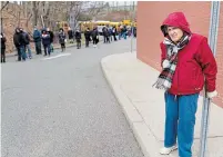  ?? SETH WENIG THE ASSOCIATED PRESS ?? Joan De Hooge supports herself on a pole while waiting for the COVID-19 vaccine in Paterson, N.J. U.S. President Joe Biden is attempting to increase vaccinatio­ns with new executive orders.