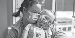  ?? PAT NABONG/CHICAGO SUN-TIMES VIA AP ?? Delilah Edwards, 3, who recently underwent a heart transplant, and her mother, Samantha Davidson, embrace at Ronald Mcdonald House’s playroom in Chicago on Wednesday morning. Delilah was born with an underdevel­oped left side of her heart.