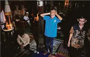  ?? Dita Alangkara / Associated Press ?? A trans woman chants the call for prayer before an early evening prayer at Al-Fatah Islamic school.