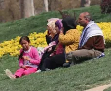  ??  ?? A Syrian family in Gezi Park in Istanbul, a city inundated with refugees.