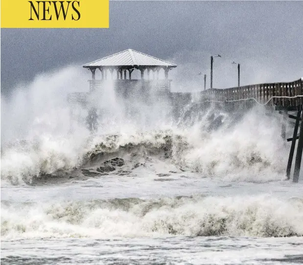  ?? TRAVIS LONG / THE NEWS & OBSERVER VIA AP ?? Waves slam the Oceana Pier and Pier House Restaurant in Atlantic Beach, N.C., on Thursday as hurricane Florence approaches the area.