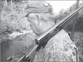  ?? Arkansas Democrat-Gazette/BRYAN HENDRICKS ?? Joe Volpe of Little Rock scans the trees for squirrels last Sunday in the Hurricane Creek Wilderness Area in Newton County. He uses a vintage Remington Model 11 20-gauge with a Poly-Choke.