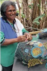  ??  ?? Erub Island’s Florence Gutchen works on large ghost-net sculptures