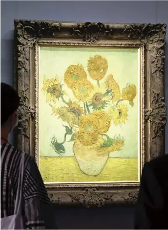  ?? Yomiuri Shimbun file photo ?? A woman looks at “Sunflowers” by Vincent Van Gogh at the Sompo Museum of Art in Shinjuku Ward, Tokyo, in 2020.