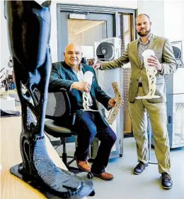  ?? NELVIN C. CEPEDA U-T ?? Herb Barrack (left) chief medical officer, and CEO Joshua Pelz at the startup’s lab on the UC San Diego campus. Barrack is holding a Limber Unileg alongside a chollas cactus, which is what inspired the design of the prosthetic limb.