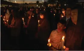  ?? Photograph: Allison Dinner/EPA ?? People pay tribute to the victims of the Monterey Park mass shooting at a candleligh­t vigil.