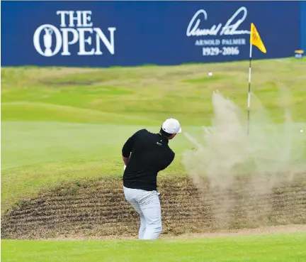  ?? STUART FRANKLIN/GETTY IMAGES ?? U.S. Open champion Brooks Koepka takes a shot from the 18th-hole bunker Thursday during the first round of the 146th British Open, at Royal Birkdale in Southport, England. His 5-under 65 put him in tie for the lead with fellow Americans Jordan Spieth...