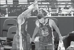  ?? JEFF CHIU — THE ASSOCIATED PRESS ?? Warriors forward Juan Toscano-Anderson, left, pours water onto guard Stephen Curry after the Warriors beat Denver on Monday.