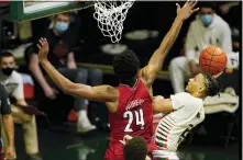  ?? MARTA LAVANDIER — THE ASSOCIATED PRESS ?? Miami’s Isaiah Wong, right, drives to the basket as Louisville’s Jae’Lyn Withers (24) defends on Saturday in Coral Gables, Fla.