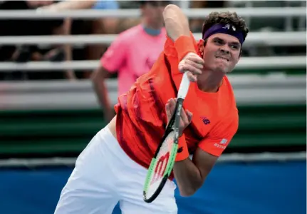  ?? — AP ?? Milos Raonic serves to Tim Smyczek in their Delray Beach Open match on Tuesday.