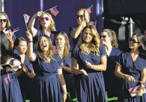  ?? BERNAT ARMANGUE AP ?? U.S. Solheim Cup team claps during the opening ceremony in Marbella, Spain, on Thursday. Competitio­n against a veteran European team runs through Sunday.