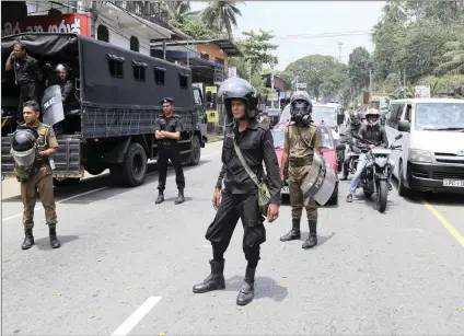  ?? PICTURE: AP ?? Sri Lankan police officers stand guard in Ambatenna, in central Sri Lanka, yesterday.