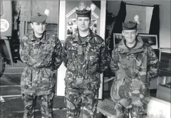  ?? 01_B49twe02 ?? The Royal Highland Fusiliers were recruiting in Arran last week. Pictured on a windswept Brodick front are Fusilier Aaron Sloan, Corporal Harkiss and Fusilier Colin Lewis.