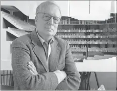  ?? AP PHOTO ?? In this April 1991 file photo, architect Robert Venturi poses in his office in the Manayunk section of Philadelph­ia, with a model of a new hall for the Philadelph­ia Orchestra in background.