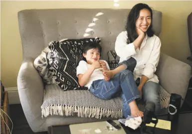  ?? Photos by Liz Hafalia / The Chronicle ?? Incoming S.F. Supervisor Connie Chan, who was born in Hong Kong, with son Edo Marsullo, 7, at home.