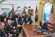  ?? LIU JIE / XINHUA ?? US President Donald Trump meets Vice-Premier Liu He (second left, front row) and answers media questions in the Oval Office at the White House in Washington on Friday.