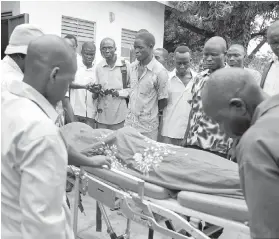  ?? JASON PATINKIN, THE ASSOCIATED PRESS ?? Mourners watch as the body of South Sudanese journalist Peter Julius Moi is taken into the mortuary in Juba, South Sudan this month. Moi was killed by two gunmen in an attack that came days after President Salva Kiir was reported to have threatened to...