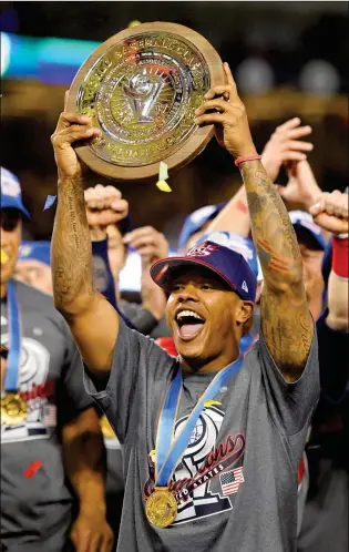  ?? ASSOCIATED PRESS ?? U.S. PITCHER MARCUS STROMAN CELEBRATES WITH THE MVP TROPHY after the the team’s 8-0 win over Puerto Rico in the final of the World Baseball Classic in Los Angeles on Wednesday.