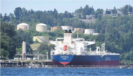  ??  ?? An oil tanker loads a shipment at Kinder Morgan’s Trans Mountain marine terminal in Burnaby. The Trans Mountain pipeline expansion project would add one tanker a day to the 10,000 large commercial vessels that travel the Juan de Fuca Strait each year, Gwyn Morgan writes.