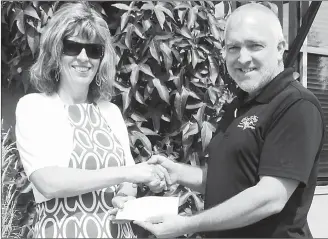  ?? Special to The Herald ?? Derek Hurst, chair of the Penticton Secondary Dry Grad committee presents Leah Schulting, executive director of the Canadian Mental Health Associatio­n-SOS with a cheque for $1,000 in the memory of Isaiah Kozak.