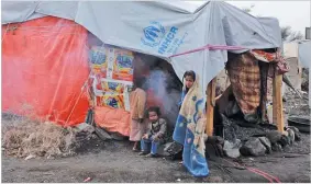  ??  ?? MOHAMMED HAMOUD/ANADOLU AGENCY Children are seen in front of makeshift tents at Darwan refugee camp in Amran north of Sana’a, Yemen, on April 11, 2018.