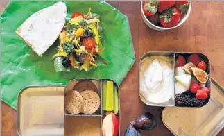  ?? Photograph­s by Christina House For The Times ?? SUZANNE GOIN and David Lentz’s kids’ lunchboxes include a vegetable sandwich on a baguette, top left, Greek yogurt with fruit, right, and almond butter with crackers, celery and apples, bottom.