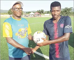  ?? (Pic: Ashmond Nzima) ?? Hat-trick hero Ayanda Gadlela receives the match ball from Premier League of Eswatini representa­tive Thulani ‘Little Known’ Mavuso, after the 4-0 win over Madlenya in an MTN Premier League match played at Mkhuzweni Technical Centre yesterday.