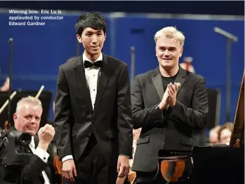  ??  ?? Winning bow: Eric Lu is applauded by conductor Edward Gardner