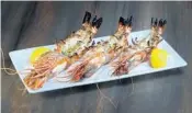  ??  ?? Sweet head-on Jumbo Prawns, seasoned and cooked at the Oliv Pit Athenian Grille, a Greek restaurant that opened in November 2017 in a Boca Raton strip shopping mall.