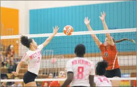  ?? STAFF PHOTOS BY COLIN STOECKER ?? Westlake outside hitter Cameran Thompson goes for the ball at the net against Chopticon junior middle hitter Caitlyn Burch in Monday night’s SMAC matchup. The Wolverines lost three sets to the Braves, 25-6, 25-4 and 25-12.