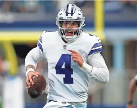  ?? TIM HEITMAN/USA TODAY SPORTS ?? Cowboys quarterbac­k Dak Prescott runs for a first down against the Carolina Panthers on Sunday in Arlington, Texas.