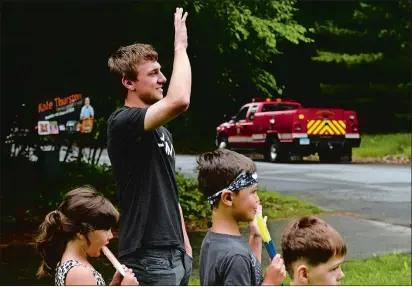  ?? DANA JENSEN/THE DAY ?? Montville senior Kole Thurston and his siblings, from left, sister Charlie Wazny, 5, and brothers Stryder Wazny, 6, and Finn Wazny, 3, watch from their front yard as the four volunteer fire companies in Montville drive down his street on June 6. The fire companies drove through town past all the high school seniors homes.