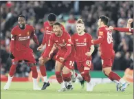  ??  ?? SPOT ON: Liverpool’s players celebrate their dramatic penalty shootout win over Arsenal at Anfield last night.