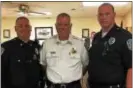  ?? SUBMITTED PHOTO ?? Collingdal­e Police Chief Robert Adams, center, poses for a picture with new corporals Patrick Kilroy, left, and William Carter.