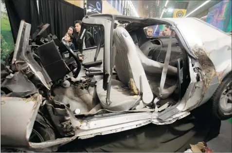  ?? NATASHA FILLION/ THE GAZETTE ?? In a campaign to create awareness for road safety at Montreal’s Internatio­nal Auto Show, the Sûreté du Québec is displaying a demolished car in which two men, Pierre-André Perron-Gaumond, 21, and Marc Chabot, 36, were killed in a fatal car crash in...