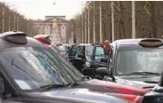  ?? Justin Tallis / AFP / Getty Images 2016 ?? Taxi drivers stage a protest in London last year, accusing Uber of taking away their business.