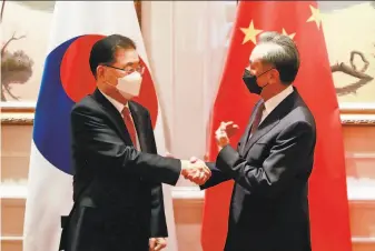  ?? Kim Yun-gu / Associated Press ?? South Korean Foreign Minister Chung Euiyong (left) greets Chinese Foreign Minister Wang Yi at their meeting in Xiamen, China. North Korea’s nuclear program was a focus of the talks.