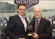  ??  ?? Neil Murphy of Wexford Chedar presents the Wexford Food Champion award to Bill Kelly of Kelly’s Hotel, Rosslare.