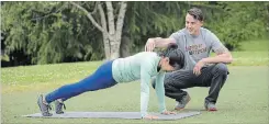  ??  ?? Nicole Tsong works with trainer Kyle Long on plank movements to begin a crawling and locomotion workout.