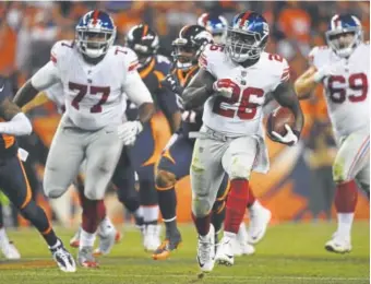  ?? Helen Richardson, The Denver Post ?? Orleans Darkwa helped the Giants pound Denver on the ground last weekend, contributi­ng 117 of their 148 yards rushing in their 23-10 victory over the Broncos.