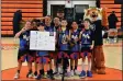  ?? ARCENIO J. TRUJILLO/Taos News ?? Members of the Nets are all smiles as they proudly give the “we’re number one” sign and pose for their championsh­ip photo with the Taos Tiger mascot Sunday (March 24). The Nets were coached by Jose and Sherry Martinez and finished in third place in the regular season standings.