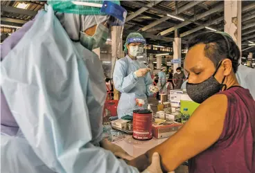  ?? ADAM DEAN/ NEW YORK TIMES FILE PHOTO ?? A man receives a COVID-19 vaccine last month during a vaccinatio­n drive in Bangkok. Countries struggling to obtain vaccines from wealthier nations may be able to make potential new vaccine, NVD-HXP-S, for themselves or acquire it at low cost from neighbors.