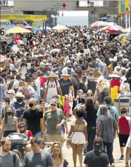  ?? Carolyn Cole Los Angeles Times ?? WITH Memorial Day, graduation­s and proms on the horizon, officials are concerned about case rates rising. Above, the Santa Monica Pier last Memorial Day.