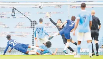  ?? — AFP photo ?? Chelsea’s Marcos Alonso (centre) shoots over Manchester City’s goalkeeper Ederson to score their late winner at the Etihad Stadium in Manchester, north west England.