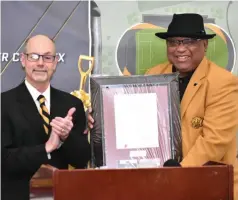  ?? Commercial/I.C. Murrell) (Pine Bluff ?? University of Arkansas System President Donald Bobbitt (left) presents a resolution honoring system board Chairman Stephen Broughton of Pine Bluff on Saturday during a groundbrea­king ceremony for the UAPB soccer and track-and-field complex.